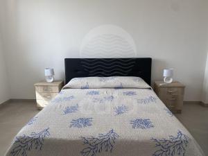 En eller flere senge i et værelse på La Torre - Piano terra By Cala Salento