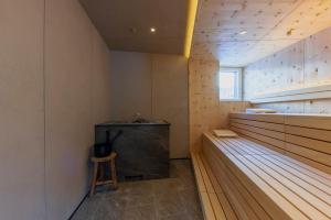 a room with a bench and a stool in a room at m3Hotel in Sankt Anton am Arlberg