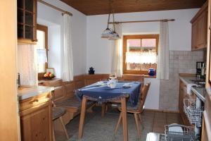 a kitchen with a table with a blue table cloth on it at Ferienhaus Wankner in Tittmoning