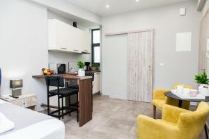 a kitchen and a living room with a table and chairs at F Spacious Brand New Studio Ideal for 3 F in Athens