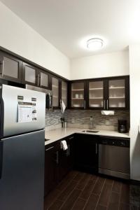 
a kitchen with a sink, stove, refrigerator and a microwave at Staybridge Suites Houston - IAH Airport, an IHG Hotel in Houston
