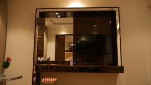 a large mirror in a hotel room with a television at OAKTREE HOTEL in Morbi