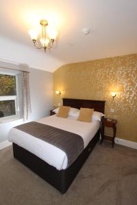 a bedroom with a large bed and a window at Fern Howe Guest House in Keswick