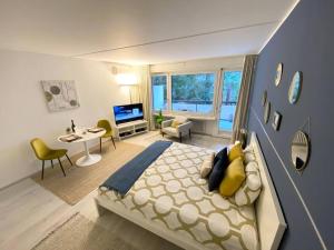1 dormitorio con 1 cama grande y sala de estar en Luganersee, Pool, Strand, Parkplatz, Suite en Bissone