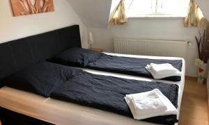 two beds in a bedroom with blue sheets and towels at Ferienwohnung Mittelbach - Whg im OG in Dierhagen