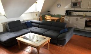 a living room with a couch and a coffee table at Ferienwohnung Mittelbach - Whg im OG in Dierhagen