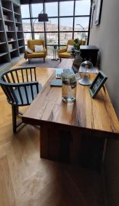 a large wooden table in a living room with a table at DESIGN hotel VERBENICUM in Vrbnik
