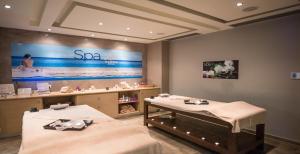 a spa room with two beds and a large screen at Royal & Imperial Belvedere Resort in Hersonissos