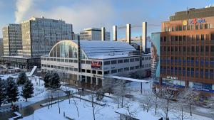 a group of buildings in a city covered in snow at 2ndhomes Luxury 1BR Kamppi Center Apartment with Sauna and Big Terrace in Helsinki