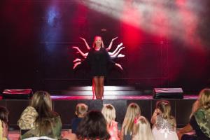 a woman standing on a stage in front of a crowd at TUI BLUE Tropical in Dalaman