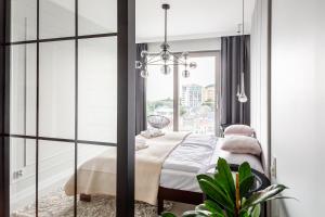 Posteľ alebo postele v izbe v ubytovaní Balticus Apartamenty Deluxe Promenada Gwiazd 14