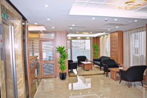 a waiting room with chairs and tables and windows at Hotel La SERA in Istanbul