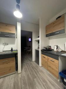 a kitchen with wooden cabinets and a counter top at 03 Gdynia Centrum - Apartament Mieszkanie dla 2 os in Gdynia