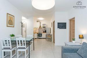 a living room and dining room with a table and chairs at Old Town by Apartmore in Gdańsk