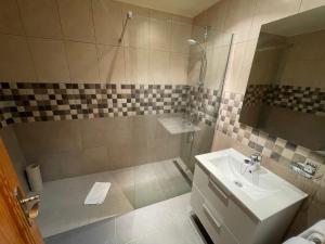 a bathroom with a sink and a shower at Fairways Club in San Miguel de Abona