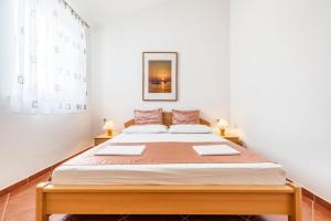 a bedroom with a large bed in a room at Apartment in Kustici with sea view, balcony, air conditioning, WiFi 3589-4 in Kustići