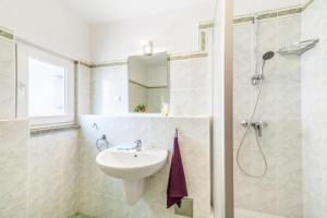 a white bathroom with a sink and a shower at Apartment in Kustici with sea view, balcony, air conditioning, WiFi 3589-4 in Kustići +40 photos