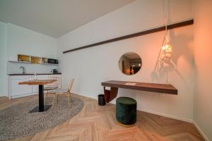 a room with a table and a mirror on the wall at Vienna House Easy by Wyndham Augsburg in Augsburg