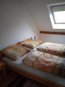 three beds lined up in a room with a window at apartman17 in Syřenov