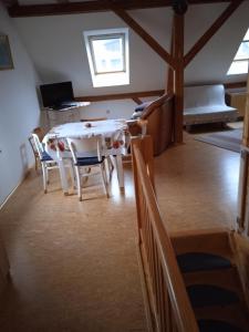 uma sala de jantar com uma mesa e cadeiras num quarto em apartman17 em Syřenov