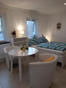 a living room with a bed and a table and chairs at Landlust! in Hoyerswerda
