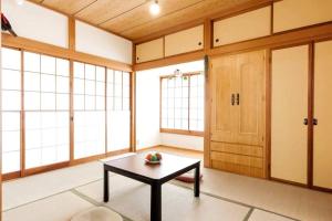 a room with a table and some windows at Forest Villa Hakone in Hakone