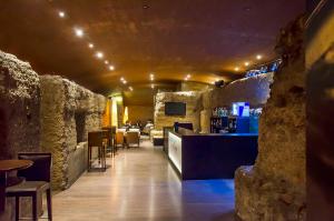 a bar in a restaurant with stone walls at Hotel Murcia Rincón de Pepe Affiliated by Meliá in Murcia