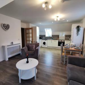 a living room with a couch and a table at Number 27 in Ullapool