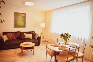 a living room with a couch and a table at Central Park Apartment Birštonas in Birštonas