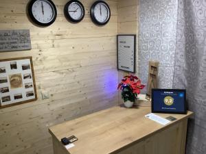 a room with clocks on the wall and a desk at Blockhaus Harzblick Standard in Hohegeiß