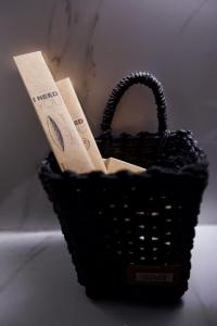 a black basket sitting on top of a table at ODI ARTSPITALITY in Volos