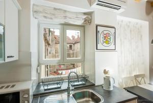 a kitchen with a sink and a window at Aldo Apartments Center in Zadar