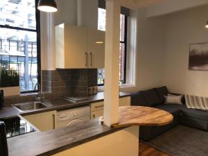 a kitchen and living room with a couch and a table at The Stanhoe in Leicester