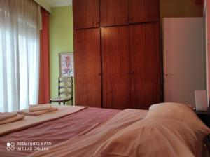 a bedroom with a bed and a cabinet and a window at Square in Komotini