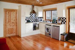 a kitchen with a stove and a dishwasher at Cottage, Manorhamilton in Manorhamilton