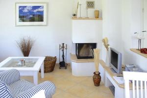 a living room with a tv and a fireplace at Semi-detached house, Zingst in Zingst
