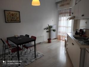 a kitchen and dining room with a table and chairs at Square in Komotini