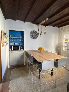 a kitchen with a wooden table and chairs at LES CLAPOTIS RUE DU PHARE QUIBERON in Quiberon