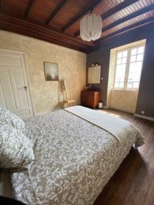 a bedroom with a bed and a window and a door at LES CLAPOTIS RUE DU PHARE QUIBERON in Quiberon