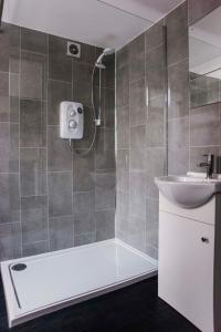 a bathroom with a bath tub and a sink at Six Bells Retreat in Abertillery