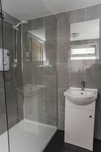 a bathroom with a shower and a sink at Six Bells Retreat in Abertillery