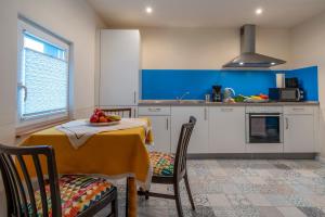 a kitchen with a table with a bowl of fruit on it at Das Blaue Haus in Boppard +31 photos
