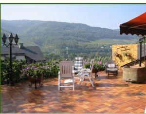 a patio with two chairs and a table with a view at Gästehaus Kiesgen-Mendgen in Bernkastel-Kues