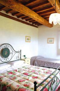 a bedroom with two beds and a wooden ceiling at Holiday home Casale le Fontanelle, Monterado in Monterado