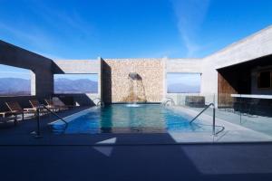 a swimming pool with a fountain in a building at Keo Hotel - Ovalle Casino Resort in Ovalle