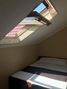 um quarto com uma cama e uma clarabóia em Ambassador Guest House em Lazarevskoye