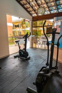 two exercise bikes in a gym with a view of a building at Aquaville Apart Hotel in Porto Seguro