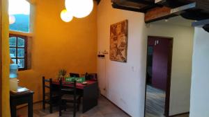 a room with a table and a dining room at Zonda hostel cultural in Lago Puelo