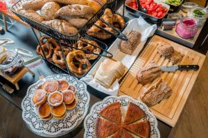 a table topped with lots of different types of bread at KOOS Hotel&Apartments - City Aparthotel in Munich