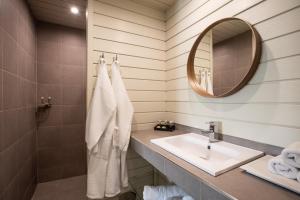 a bathroom with a sink and a mirror at Blue Sail Hotel in Anse Marcel  +37 photos